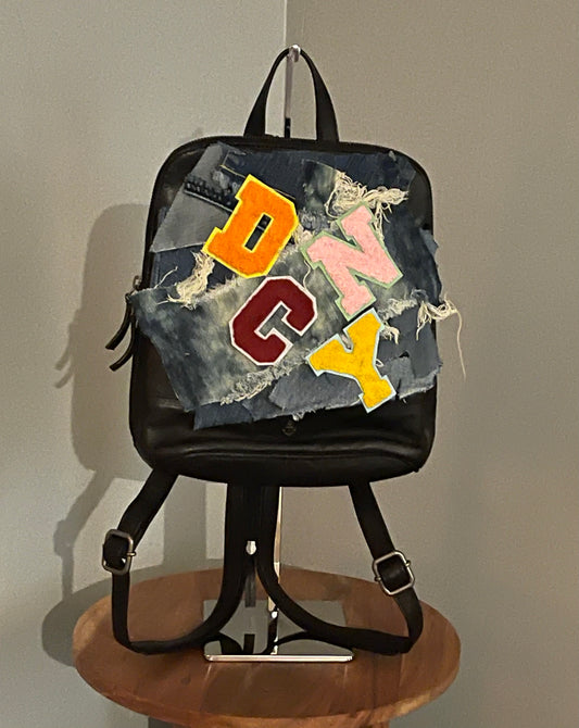 THE DC/NY MEDIUM DENIM BLACK LEATHER BACKPACK